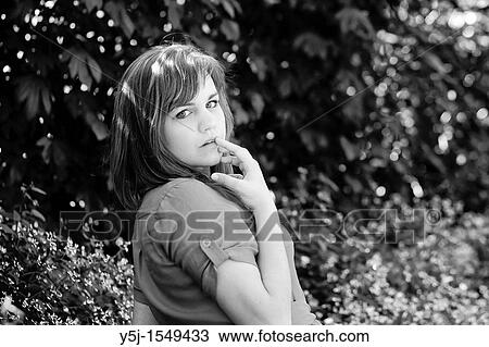 Young Caucasian female looking over her shoulder View Large Photo Image Stock Image - Young Caucasian female looking over her shoulder. Fotosearch