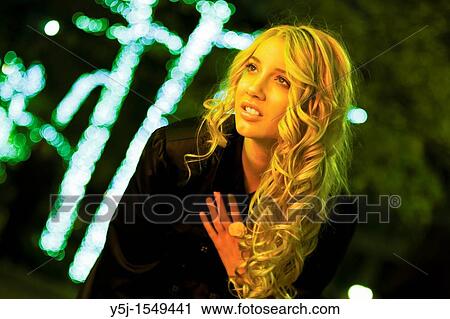 Young Caucasian female standing under yellow streetlight View Large Photo Image Stock Image - Young Caucasian female standing under yellow streetlight. Fotosearch