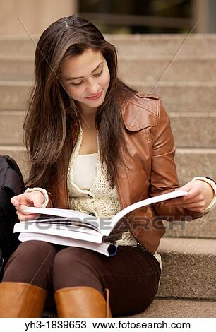 Young caucasian girl reading textbook at a university library View Large Photo Image Stock Image - Young caucasian girl reading textbook at a university library. Fotosearch