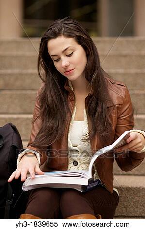 Young caucasian girl reading textbook at a university library View Large Photo Image Stock Photography - Young caucasian girl reading textbook at a university library. Fotosearch