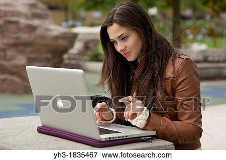 Young caucasian girl using MacBook Pro laptop outdoor View Large Photo Image Stock Photo - Young caucasian girl using MacBook Pro laptop outdoor. Fotosearch