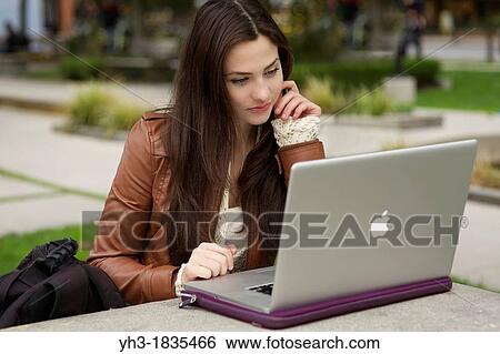 Young caucasian girl using MacBook Pro laptop outdoor View Large Photo Image Stock Photograph - Young caucasian girl using MacBook Pro laptop outdoor. Fotosearch