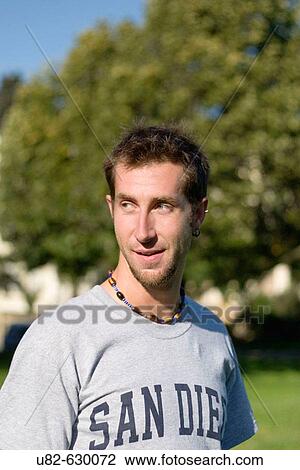 Stock Image - Young Caucasian man at Duboce Park, San Francisco, California, USA.. Fotosearch