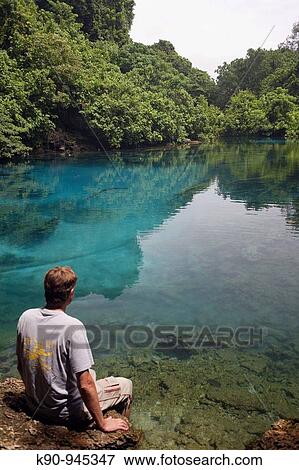 Young caucasian man seen from behind sitting at Blue Hole, Espiritu Santo, Vanuatu, Melanesia, South Pacific View Large Photo Image Stock Photo - Young caucasian man seen from behind sitting at Blue Hole, Espiritu Santo, Vanuatu, Melanesia, South Pacific. Fotosearch