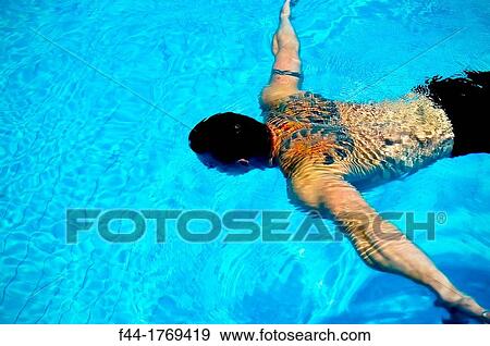 Young Caucasian musle man with tattoos swimming in pool View Large Photo Image Stock Photo - Young Caucasian musle man with tattoos swimming in pool. Fotosearch