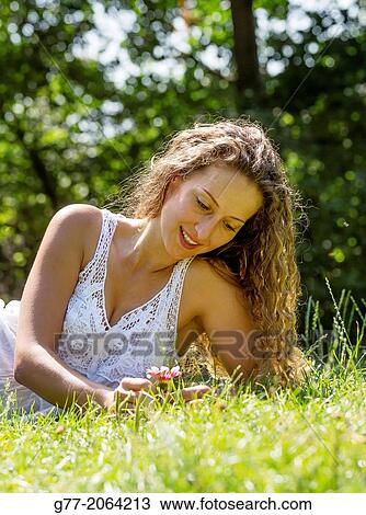 Young caucasian woman 33 years outdoor smiling in a meadow. View Large Photo Image Stock Image - Young caucasian woman 33 years outdoor smiling in a meadow.. Fotosearch
