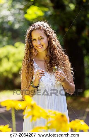 Young caucasian woman 33 years outdoor among flowers. View Large Photo Image Stock Photo - Young caucasian woman 33 years outdoor among flowers.. Fotosearch