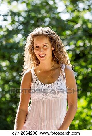 Young caucasian woman 33 years outdoor among flowers. View Large Photo Image Stock Photo - Young caucasian woman 33 years outdoor among flowers.. Fotosearch