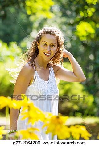 Young caucasian woman 33 years outdoor among flowers. View Large Photo Image Stock Photograph - Young caucasian woman 33 years outdoor among flowers.. Fotosearch