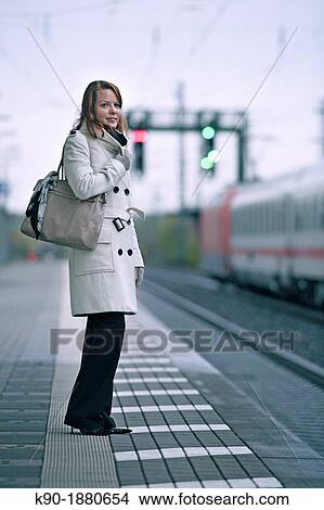 Young caucasian woman at a train station View Large Photo Image Picture - Young caucasian woman at a train station. Fotosearch