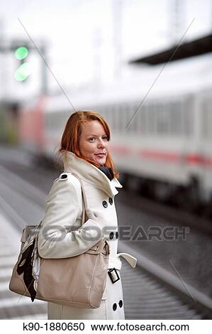 Young caucasian woman at a train station View Large Photo Image Stock Image - Young caucasian woman at a train station. Fotosearch