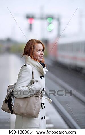 Young caucasian woman at a train station View Large Photo Image Stock Image - Young caucasian woman at a train station. Fotosearch