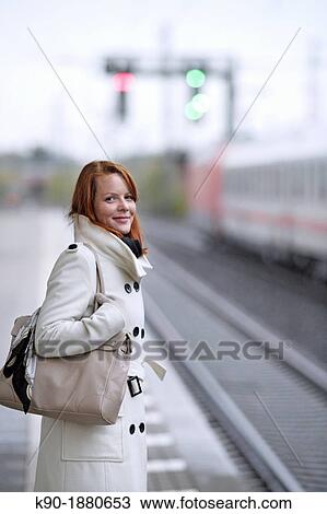 Young caucasian woman at a train station View Large Photo Image Stock Image - Young caucasian woman at a train station. Fotosearch