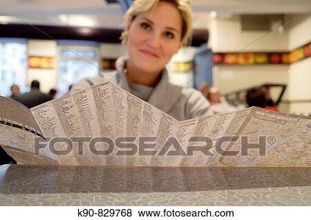 Stock Photo - Young caucasian woman looking over the map of New York City, New York, United States, North America. Fotosearch