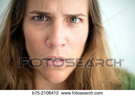 Young Caucasian woman with blond hair and green eyes with scared expression. View Large Photo Image Stock Image - Young Caucasian woman with blond hair and green eyes with scared expression.. Fotosearch