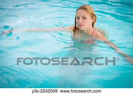 Young Caucasian woman with wet blond hair enjoying bath in swimming pool. View Large Photo Image Stock Photo - Young Caucasian woman with wet blond hair enjoying bath in swimming pool.. Fotosearch
