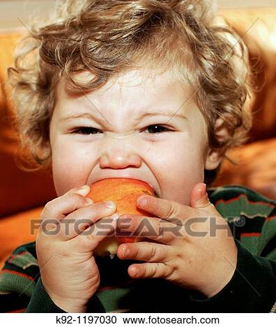 Young child eating an apple. View Large Photo Image Stock Image - Young child eating an apple.. Fotosearch