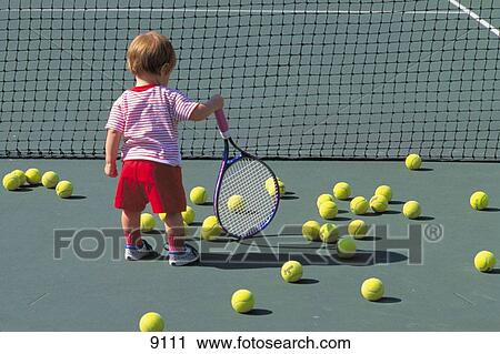 Young child holding tennis racquet View Large Photo Image Stock Image - Young child holding tennis racquet. Fotosearch