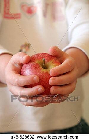 Young child offering apple View Large Photo Image Stock Image - Young child offering apple. Fotosearch