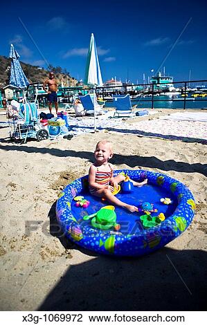Young child plays in his personal pool on the beach in Avalon, Santa Catalina Island, California, USA View Large Photo Image Stock Image - Young child plays in his personal pool on the beach in Avalon, Santa Catalina Island, California, USA. Fotosearch