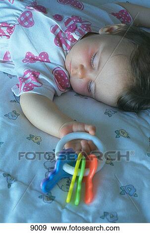 Young child sleeping with keys in hand View Large Photo Image Stock Photo - Young child sleeping with keys in hand. Fotosearch