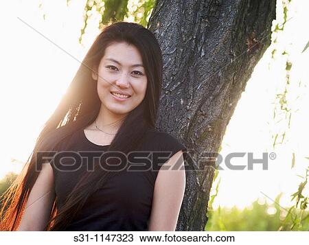 Stock Image - young chinese woman visiting the 2010 shanghai expo. Fotosearch
