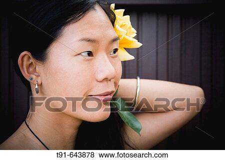 young Chinese women with a flower in her hair View Large Photo Image Stock Photo - young Chinese women with a flower in her hair. Fotosearch