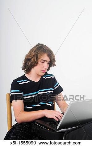 Young college Teen boy with a laptop computer View Large Photo Image Stock Image - Young college Teen boy with a laptop computer. Fotosearch
