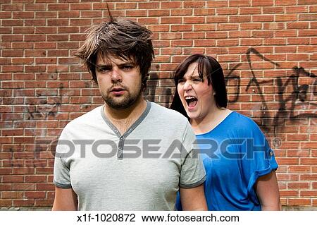 Stock Image - Young couple arguing, shouting, relationship breakdown. Fotosearch