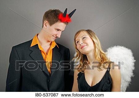 Young couple as angel and devil View Large Photo Image Stock Photo - Young couple as angel and devil. Fotosearch