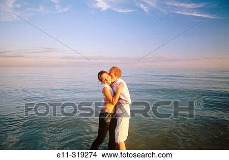 Young couple at beach View Large Photo Image Picture - Young couple at beach. Fotosearch