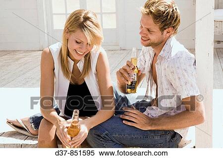 Young couple at home chilling out View Large Photo Image Stock Photography - Young couple at home chilling out. Fotosearch