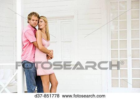 Young couple at home embracing eachother View Large Photo Image Stock Photo - Young couple at home embracing eachother. Fotosearch