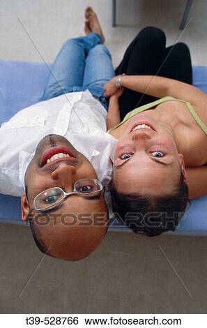 Young couple at home View Large Photo Image Stock Photograph - Young couple at home. Fotosearch