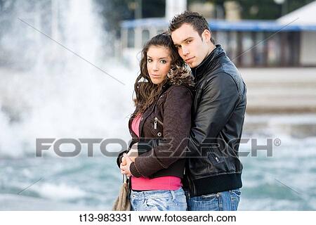 Young couple before high waves View Large Photo Image Stock Image - Young couple before high waves. Fotosearch