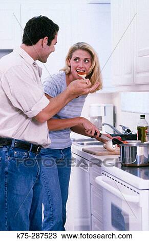 Young couple cooking together View Large Photo Image Stock Image - Young couple cooking together. Fotosearch