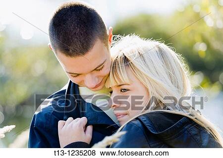 Young couple cuddling View Large Photo Image Stock Photo - Young couple cuddling. Fotosearch