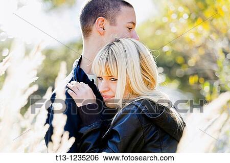 Young couple cuddling View Large Photo Image Stock Photograph - Young couple cuddling. Fotosearch