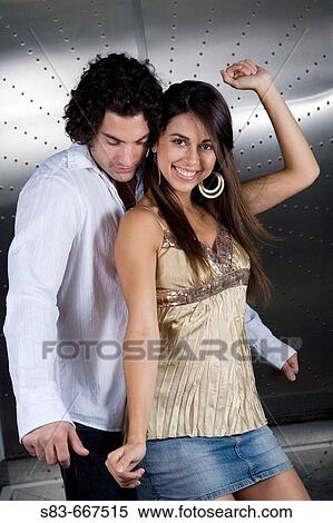 Stock Photography - young couple dancing at club. Fotosearch