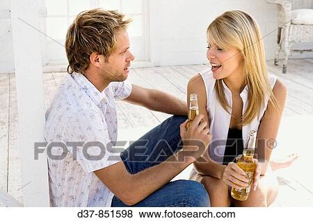 Young couple drinking a beer View Large Photo Image Stock Photo - Young couple drinking a beer. Fotosearch