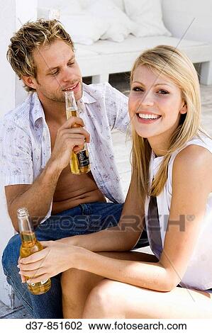 Young couple drinking beer View Large Photo Image Stock Image - Young couple drinking beer. Fotosearch