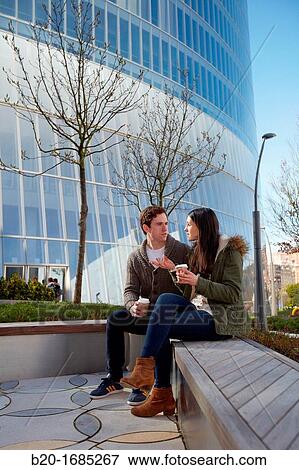 Young couple drinking coffee in the city, Iberdrola Tower, Abandoibarra, Bilbao, Bizkaia, Basque Country, Spain View Large Photo Image Stock Photo - Young couple drinking coffee in the city, Iberdrola Tower, Abandoibarra, Bilbao, Bizkaia, Basque Country, Spain. Fotosearch