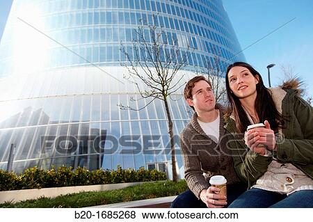 Young couple drinking coffee in the city, Iberdrola Tower, Abandoibarra, Bilbao, Bizkaia, Basque Country, Spain View Large Photo Image Stock Photo - Young couple drinking coffee in the city, Iberdrola Tower, Abandoibarra, Bilbao, Bizkaia, Basque Country, Spain. Fotosearch