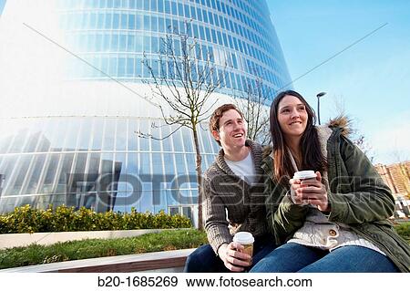 Young couple drinking coffee in the city, Iberdrola Tower, Abandoibarra, Bilbao, Bizkaia, Basque Country, Spain View Large Photo Image Stock Photo - Young couple drinking coffee in the city, Iberdrola Tower, Abandoibarra, Bilbao, Bizkaia, Basque Country, Spain. Fotosearch