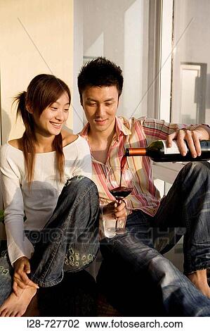 Stock Image - Young Couple Drinking Wine. Fotosearch