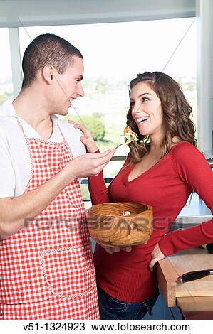 Young couple eating salad in the kitchen View Large Photo Image Stock Image - Young couple eating salad in the kitchen. Fotosearch