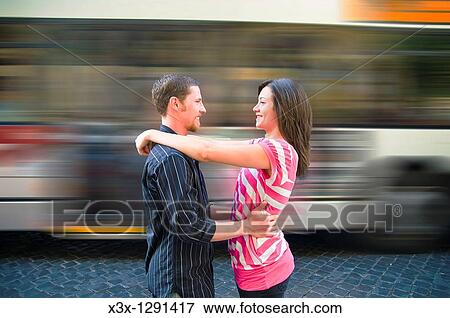 Young couple embracing at train station View Large Photo Image Stock Photo - Young couple embracing at train station. Fotosearch