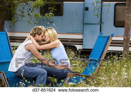 Young couple embracing each other outdoors View Large Photo Image Picture - Young couple embracing each other outdoors. Fotosearch
