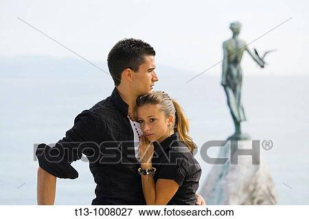 Young couple, famous? Girl with a seagull? in background - Opatija in Croatia View Large Photo Image Stock Photo - Young couple, famous? Girl with a seagull? in background - Opatija in Croatia. Fotosearch