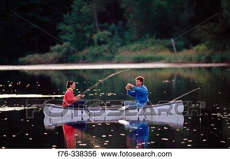 Young couple fishing from canoe winter pond View Large Photo Image Stock Photograph - Young couple fishing from canoe winter pond. Fotosearch